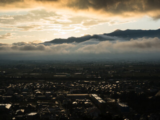 Naklejka premium Sunset over Matsumoto city and Northern Alps, scenic view from Joyama park observation tower - Nagano prefecture, Japan
