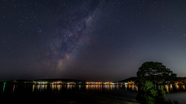 Stars, city lights and the milky way over the bay