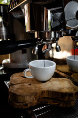 Fresh espresso shot pouring out of machine.