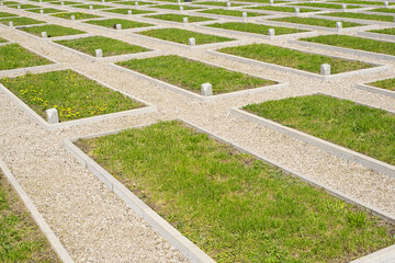 Military cemetery with graves of soldiers. Minimalistic headstones.