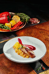 foie gras with citrus chutney and mango sorbet on a white plate on a copper background. 