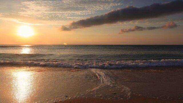 Tropical ocean beach sunrise with colorful sky clouds and sea waves
