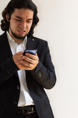 Hispanic man in black suit demonstrating a negative attitude on a white background