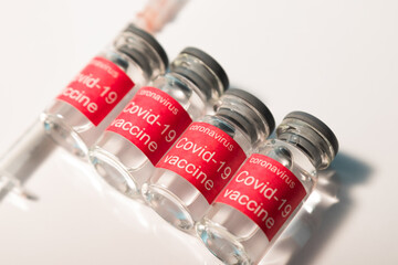 Bottle vial of Covid-19 coronavirus vaccine on  background of covid-19 quarantine