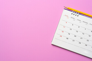 close up of calendar on the pink table background, planning for business meeting or travel planning...