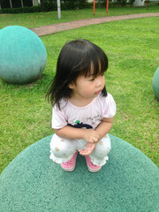 little child playing with ball in the park