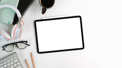 Flay lay, Top view white office desk with digital talet with empty screen , headphone, glasses,...