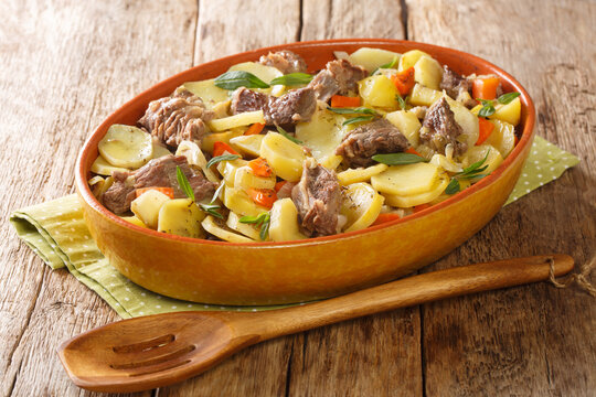Alsatian Meat and Vegetable Stew Baeckeoffe close-up in a pot on the table. Horizontal