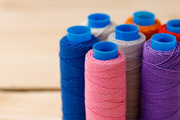 Close up of colored thread coils, thread spools background