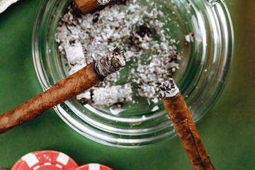 Cigars in an ash tray close up - obrazy, fototapety, plakaty