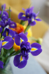 Fototapeta na wymiar Lush bouquet with yellow tulips and irises