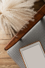 Blank screen tablet on vintage chair. Flat lay, top view minimalist blog, website, app template. Copy space pad mockup.