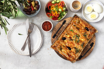 traditional breakfast with fresh pastries, salad, olives and coffee