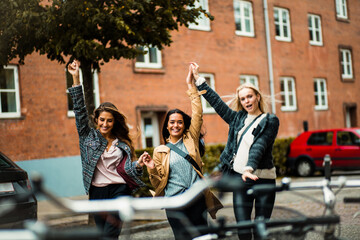 Three women having fun on the street.