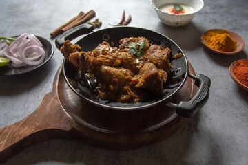 Chicken kasha or chicken cooked with Indian spices, onion and ginger garlic paste and yogurt. A spicy semi dry food item. Close up, selective focus.