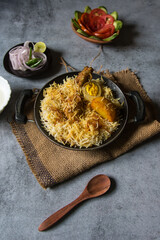 Indian Mughlai cuisine dum biryani or rice cooked with Indian spices and meat. Top view.