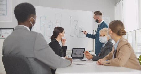 Diverse business team at training in medical face mask - Powered by Adobe