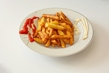 Homemade French fries with ketchup in mayonnaise sauce.