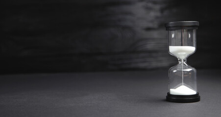 Hourglass on the black background.
