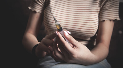 Drug addict with a syringe at home.