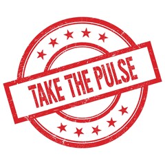 TAKE THE PULSE text written on red vintage round stamp.