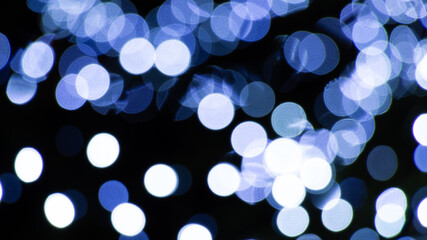 Abstract background of white and blue light halos or circles in a tree
