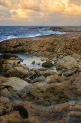 Fototapeta na wymiar Beautiful autumn night on a rocky beach in Qawra, Malta.