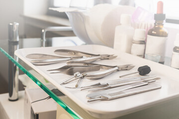 Medical instruments on a white tray. Chiropody tools. Nail nippers and nail rasps.
