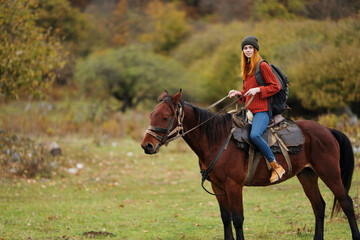 woman hiker travel mountains nature riding horse landscape