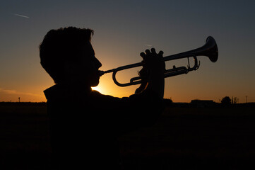 silhouette of a person with a trumpet
