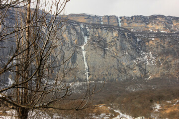 Beautiful frozen waterfall in the mountains.