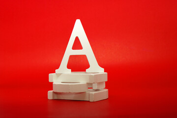 A white letter word wooden Isolated Red Background with Copy Space - Advertise object symbol or the...