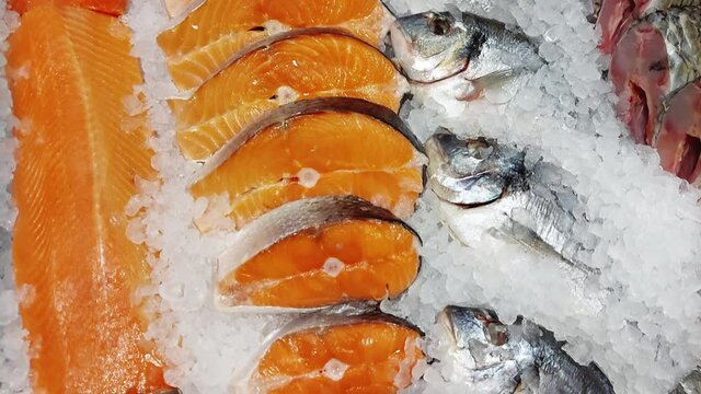 Red fish trout are sold on display in a store. Delicious and healthy sea food, frozen