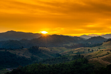 Beautiful sunrise over the mountain range at the west of thailand, nature landscape twilight background .