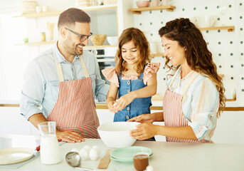 family child kitchen food daughter mother father cooking preparing pancake breakfast  happy together