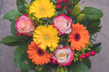 Greetings, anniversary or Mother’s Day concept: Close up of colorful fresh spring flower bouquet with gerbera and pink roses