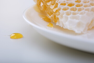 Honey background. Sweet honey in the comb, glass jar.
