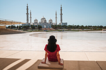 Woman enjoying view of Sheikh Zayed Grand Mosque in Abu Dhabi, United Arab Emirates on a sunny day