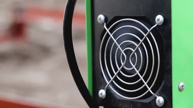 Spinning cooler in the welding machine for cooling. Portable modern welding machine for work, industry