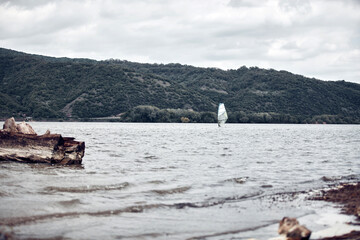Fototapeta premium Windsurfer surfing on a windy day at the river.