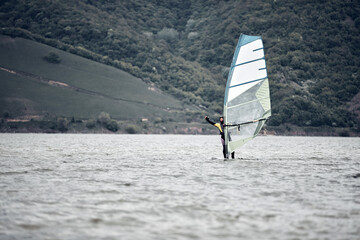 Windsurfer surfing on a windy day at the river.