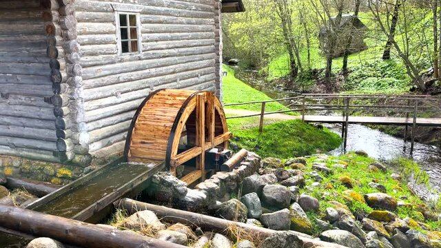 Historic grist mill with a working water wheel, spring summer time, no people. 