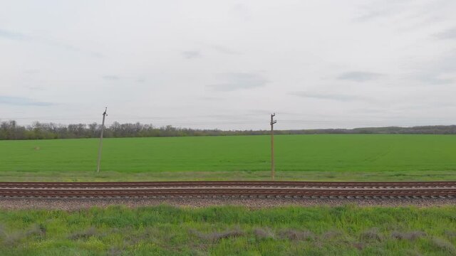 Green field railroad aerial drone view side camera movement