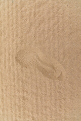A shoe footprint in some sand