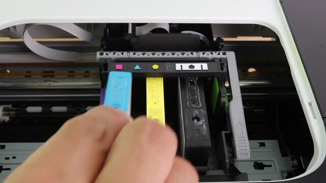 Technicians are install setup the ink cartridge or inkjet cartridge is a component of an inkjet printer 