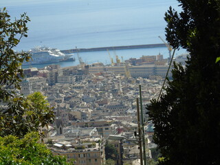 Genova, Italy - May 09, 2021: Panoramic view of the port Genoa, Italy. View from the sea to the old town, and the port on spring sunny day. Genoa bay, harbor, yacht at the pier. Tourist destinations.