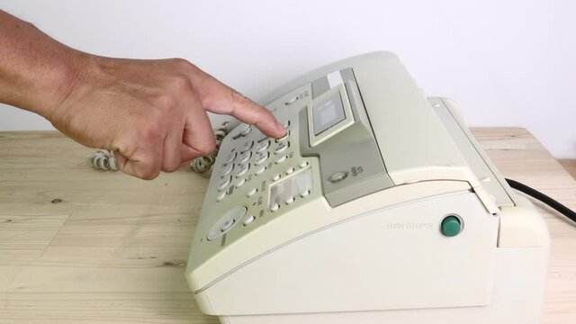 hand man are using a fax machine in the office, equipment for data transmission.