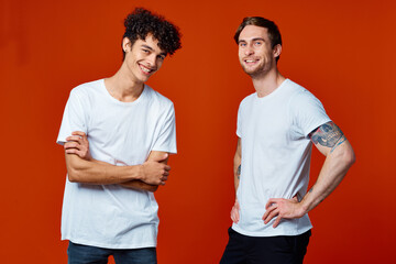 funny two men in white t-shirts on a red background friendship