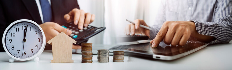 businessman holding coins putting in glass and using calculator. concept saving money and finance accounting.