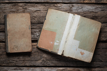 Open old book on the wooden desk table flat lay background.